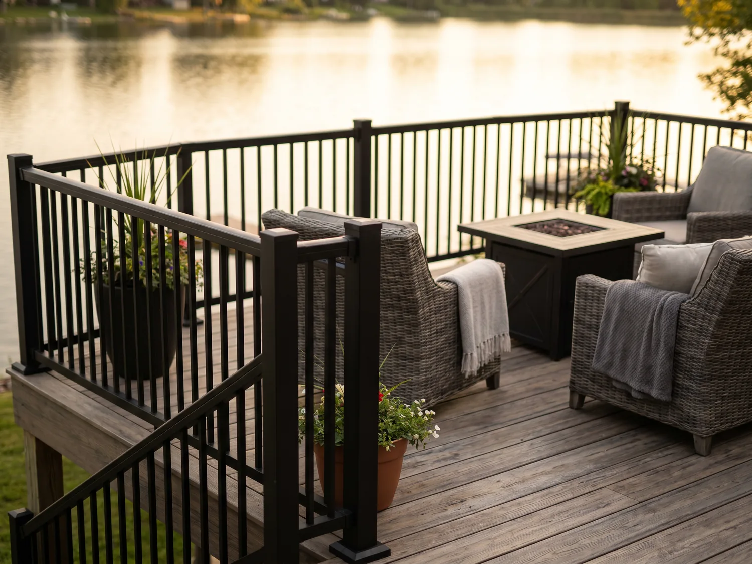 Backyard composite deck with aluminum railings overlooking a lake